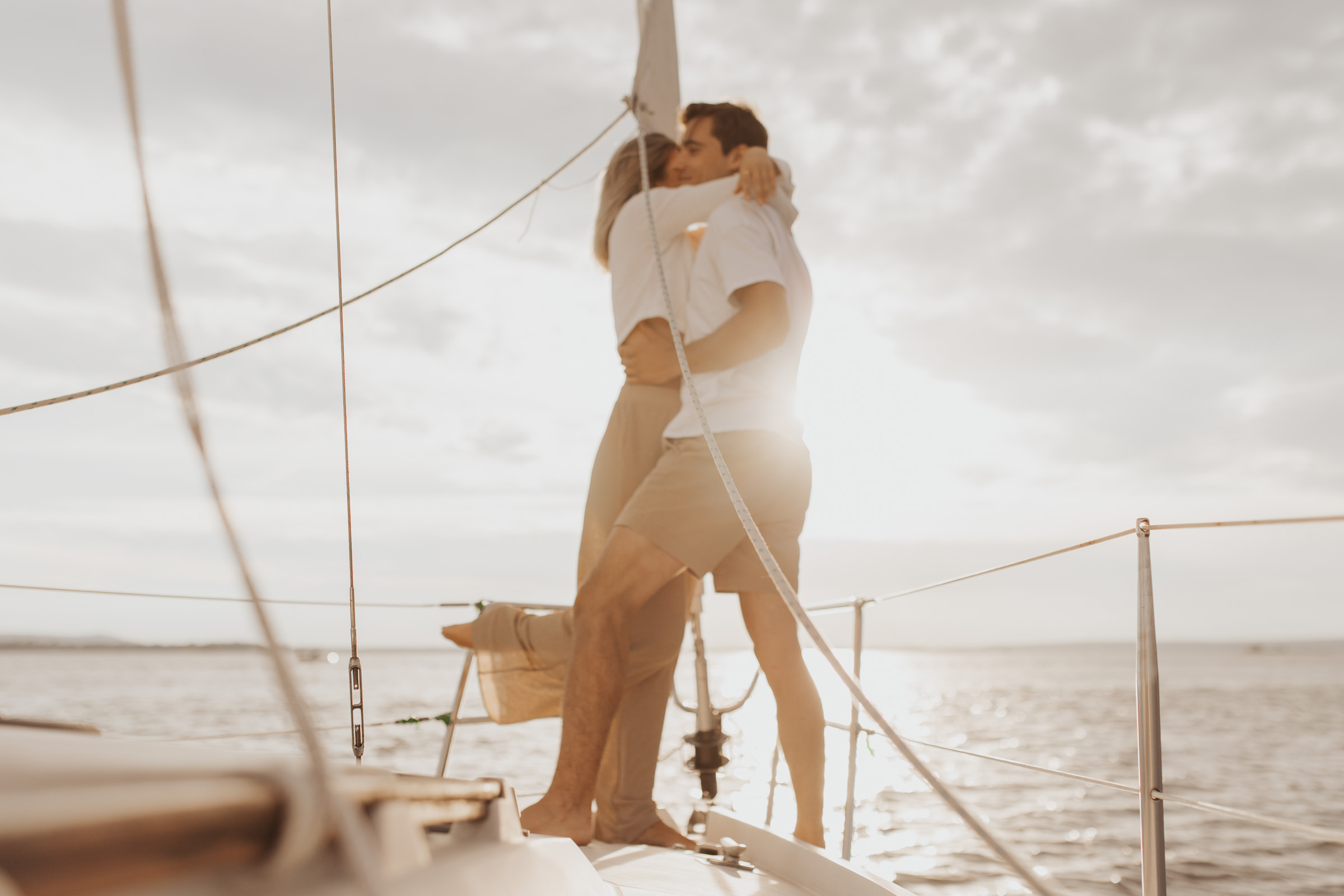 engagement photo session on a sailboat at sunset