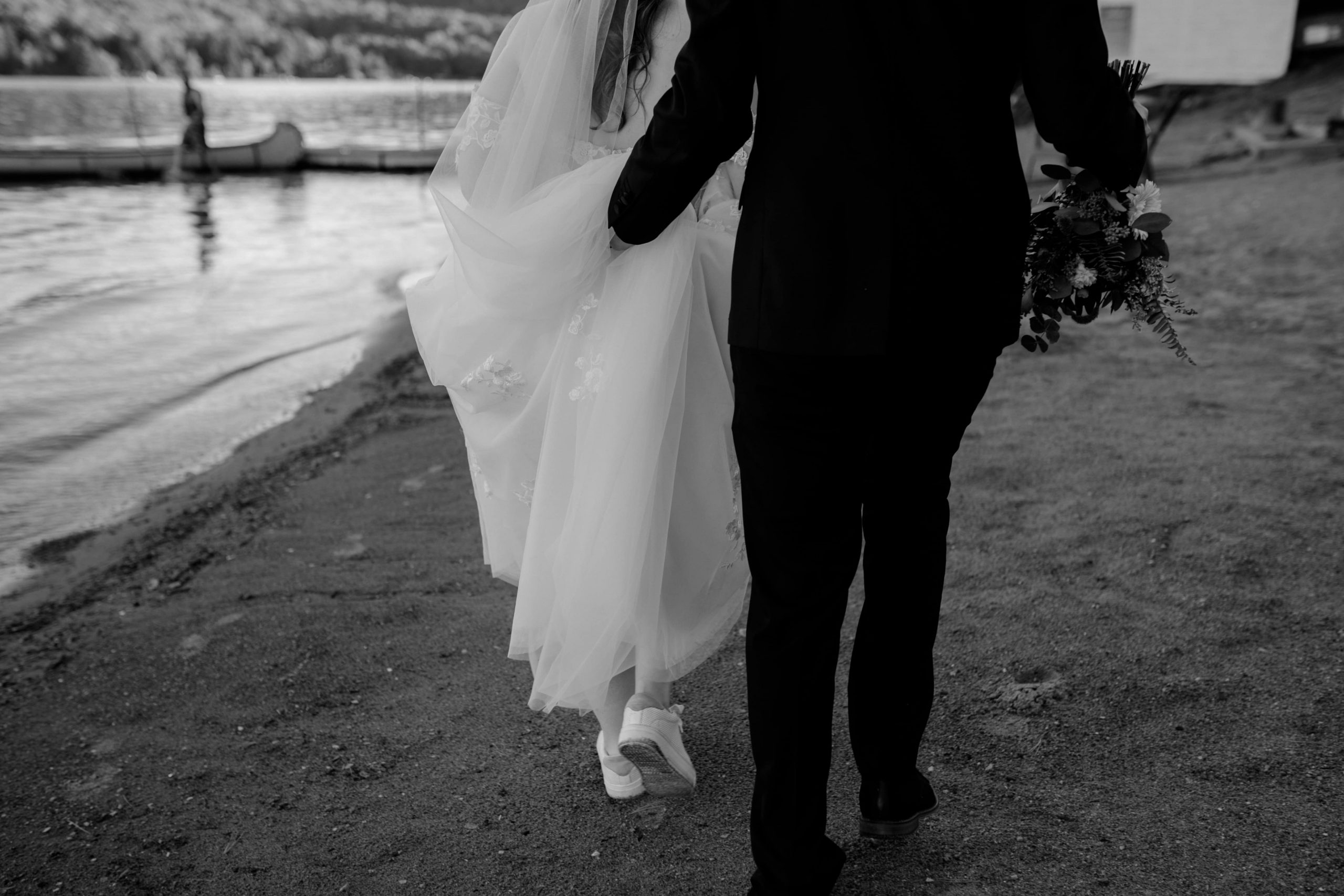 montreal micro wedding with groom holding brides wedding dress